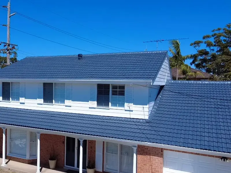 Two-storey house with a finished deep-blue tiled roof