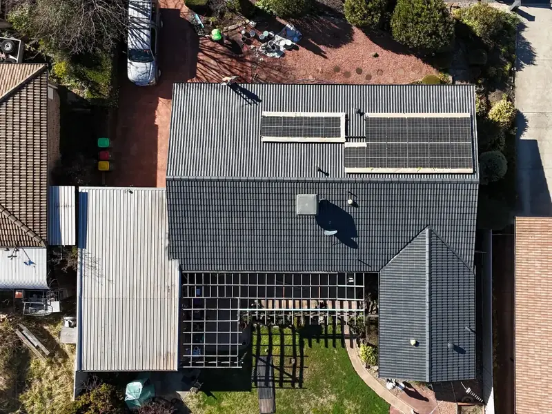 The same roof from the drone after restoration, recoated in charcoal